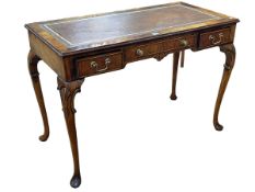 Leather topped writing table on cabriole legs, 111cm wide.