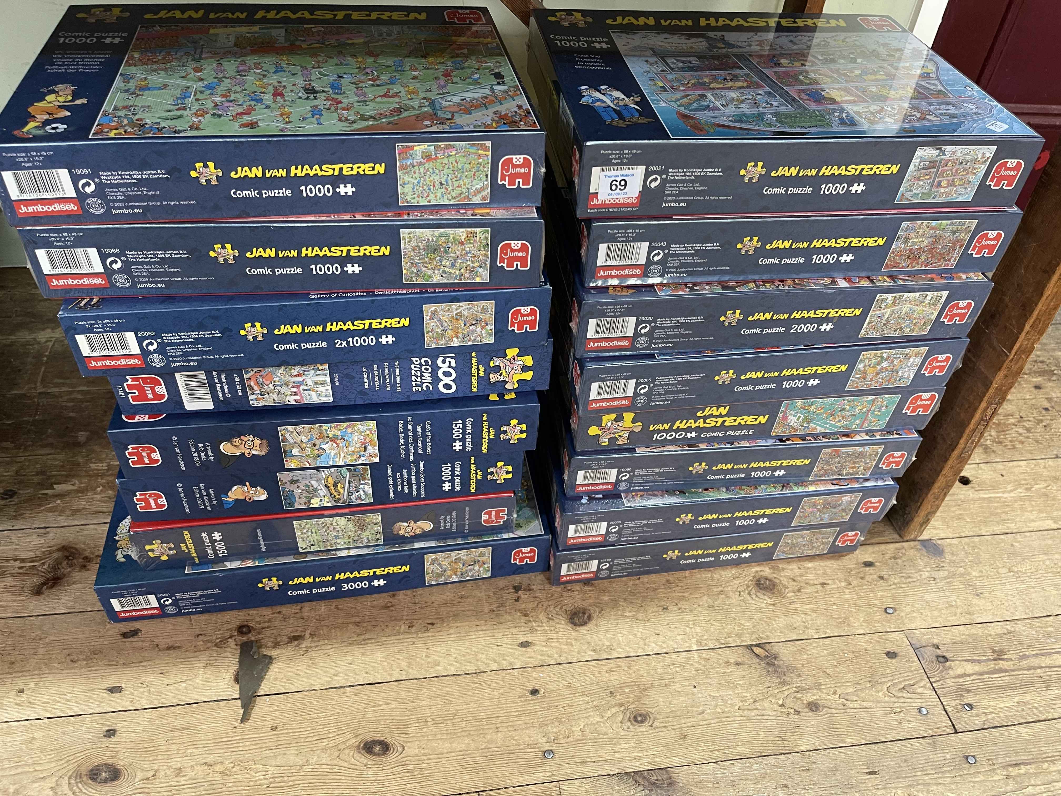 Sixteen Jan Van Haasteren jigsaw puzzles.