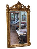 Large ornate gilt framed bevelled wall mirror mounted to each corner with winged cherubs,