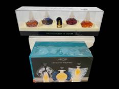 Two boxed Lalique and Dali miniature perfume sets.
