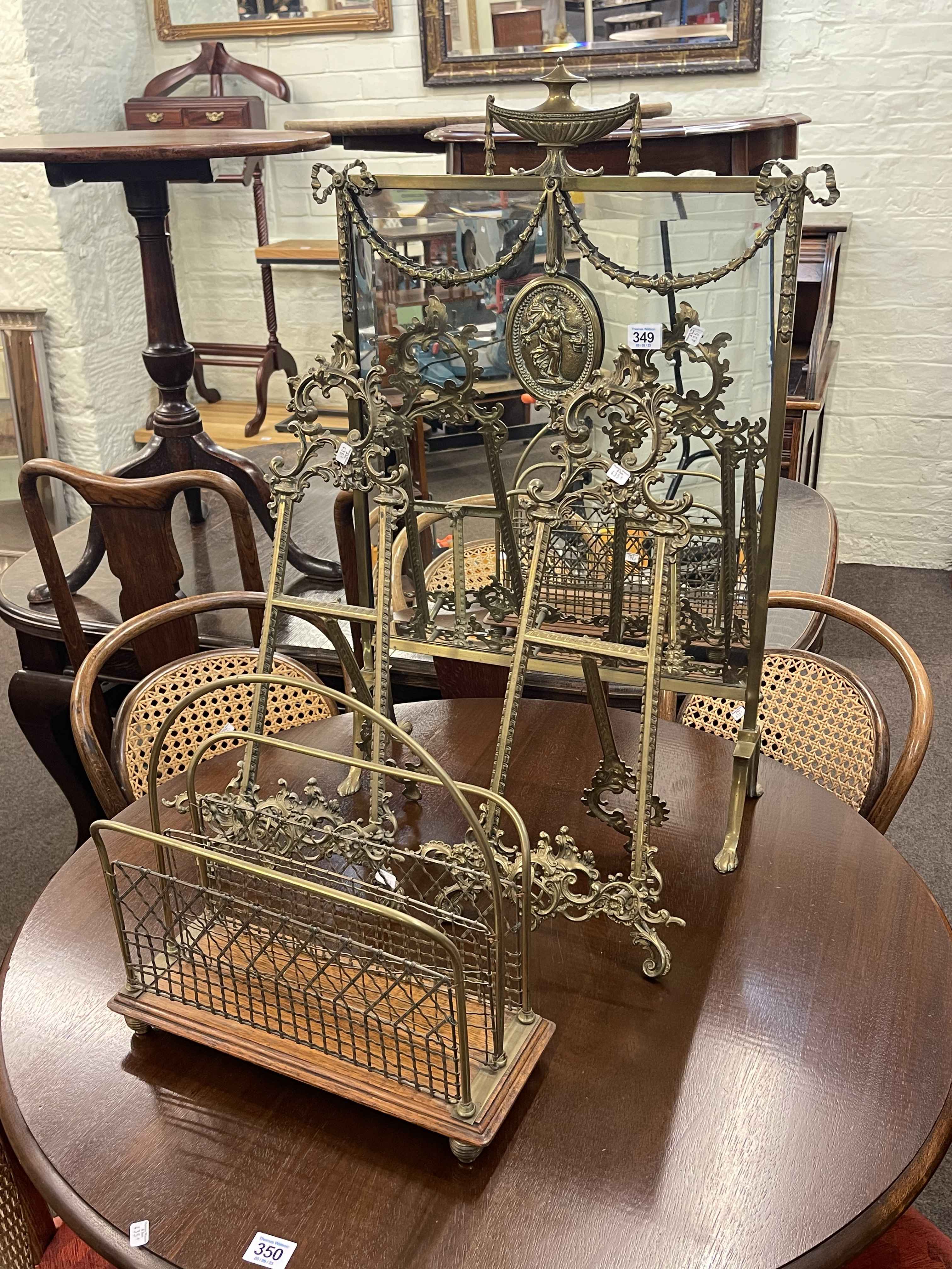 Ornate brass and mirrored firescreen, pair of ornate brass easel stands and small magazine rack.