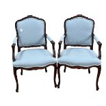 Pair of mahogany framed armchairs in blue patterned fabric.