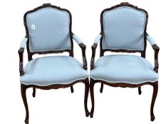 Pair of mahogany framed armchairs in blue patterned fabric.