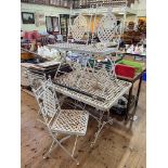 Metal lattice work design garden table and six folding chairs, table 153cm by 76cm.