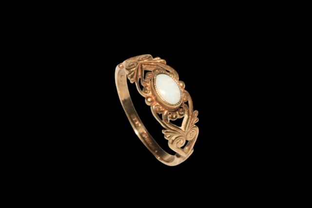 9 carat yellow gold and opal ladies ring with pierced shoulders.
