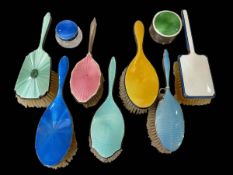 Six silver and enamel hair brushes, chrome brush and two jars (9).