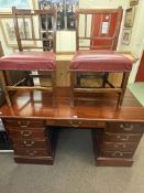 Mahogany nine drawer pedestal desk and pair of antique oak side chairs, desk 77cm by 145cm by 66cm.