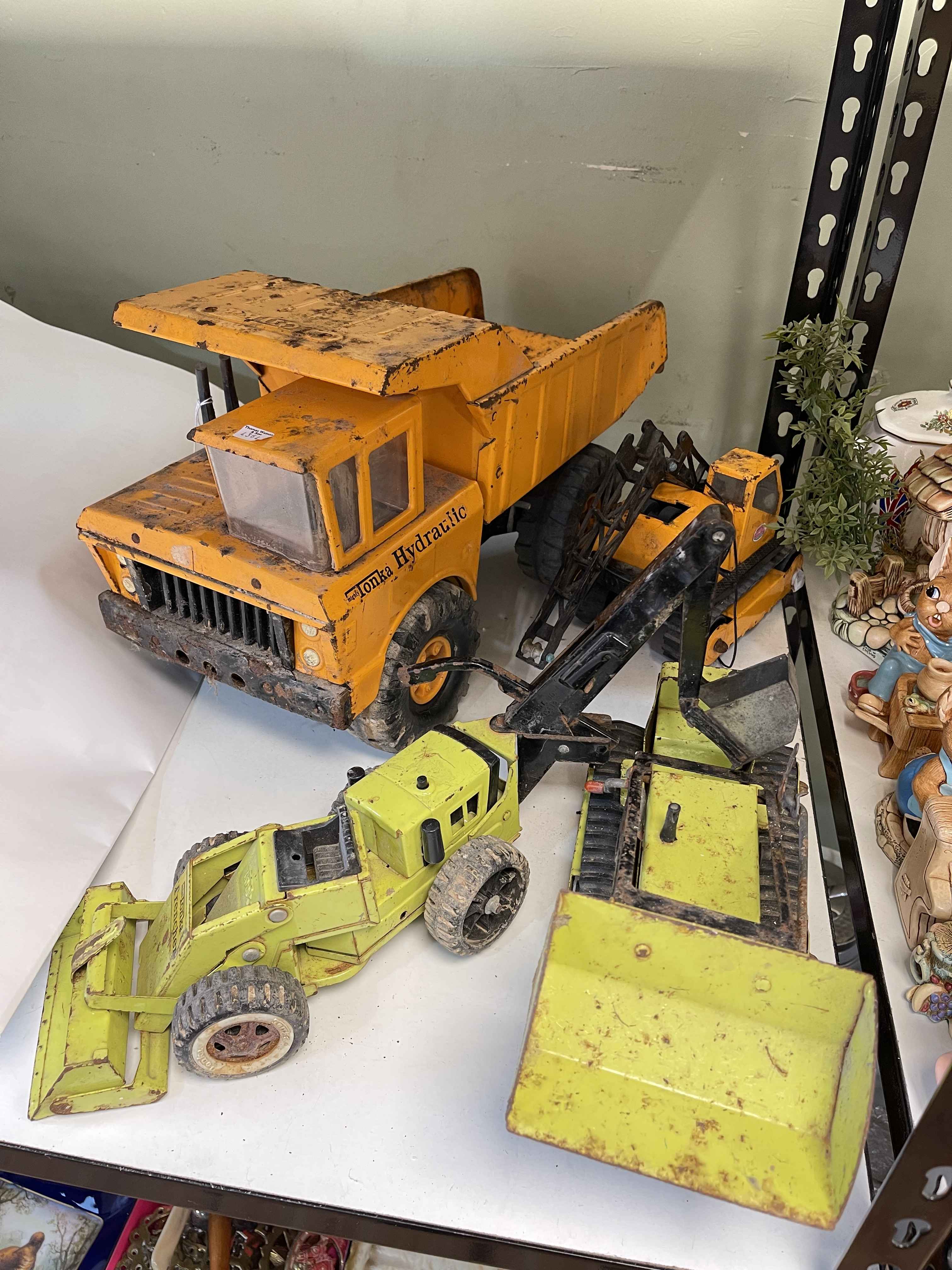 Collection of Tonka trucks and diggers.