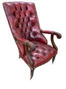 Red leather button back library chair on turned legs.