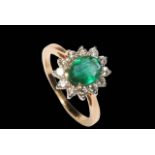 Emerald and diamond cluster ring set in 18 carat yellow gold, the central oval emerald 1.