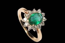 Emerald and diamond cluster ring set in 18 carat yellow gold, the central oval emerald 1.