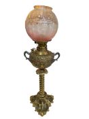 Ornate twist column brass oil lamp with etched pink glass shade.