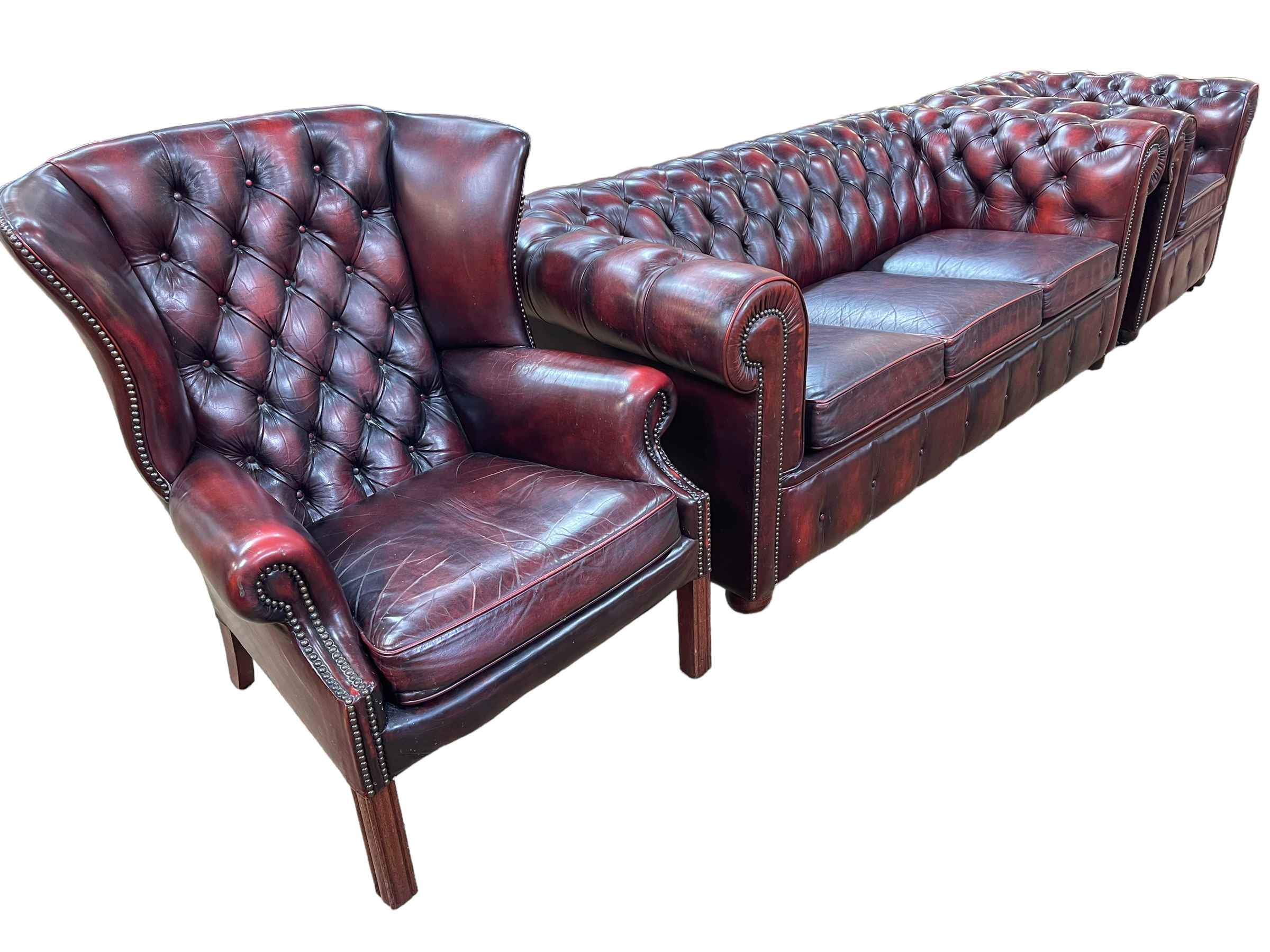 Three piece button backed ox blood leather three seater Chesterfield suite.