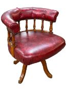 Red leather button back and oak swivel office chair.