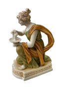 Royal Dux figure of maiden kneeling with ewer and tazza, 21cm.