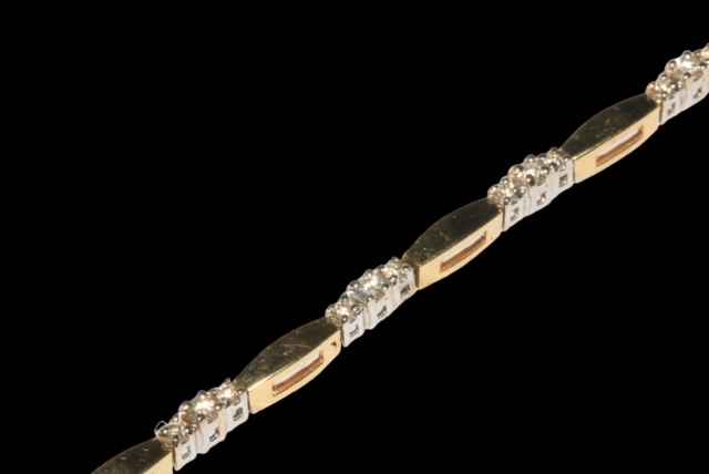 Diamond set bracelet in two colour 14k gold, having ten links set with 30 diamonds, 17.5cm length. - Image 2 of 2