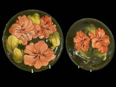 Two Moorcroft 'Hibiscus' plates, largest 26cm diameter.