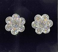 Very impressive diamond cluster 18k white gold earrings, each set with seven diamonds,