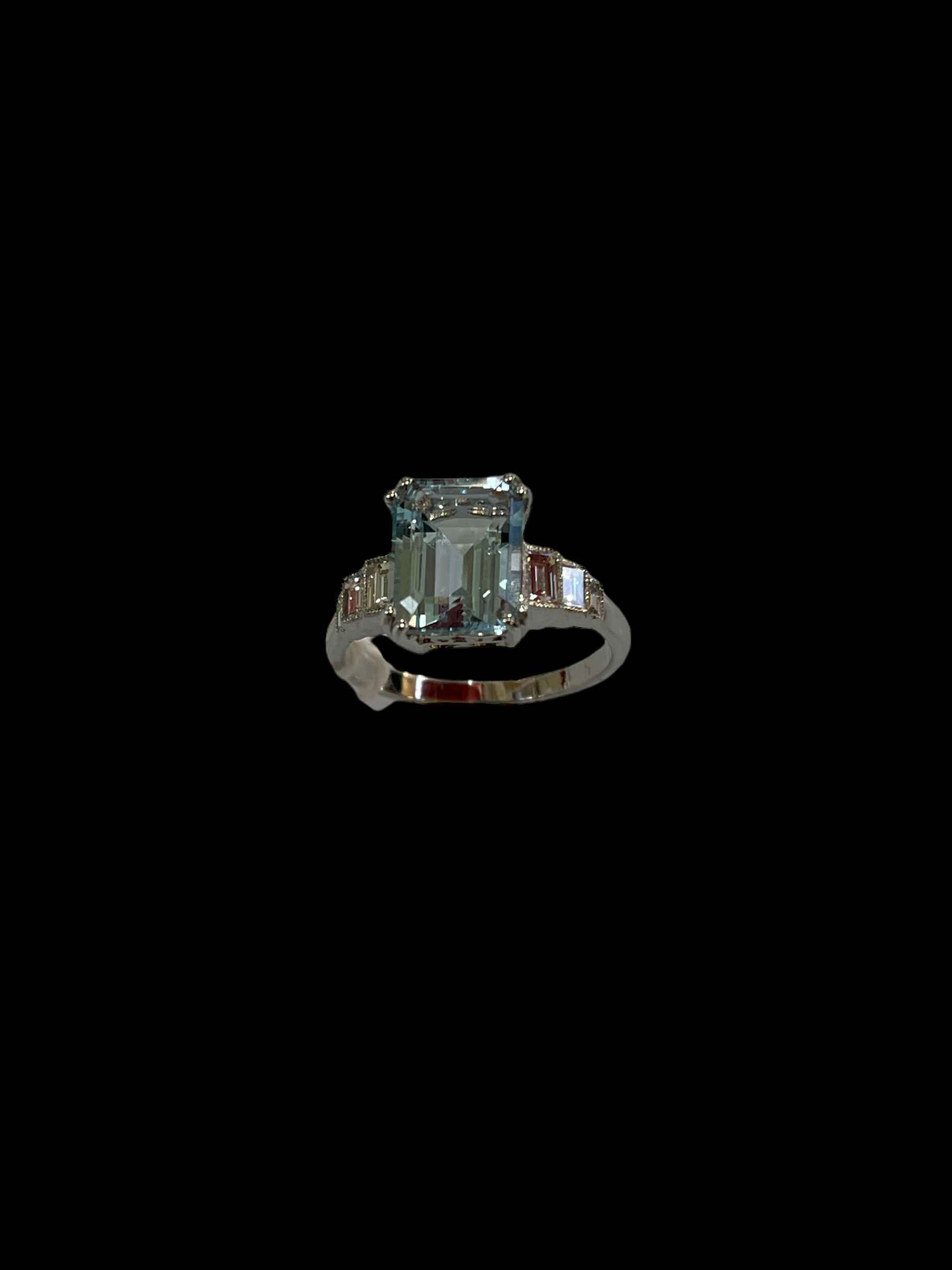 Aquamarine and diamond white gold ring, having 1.5 carat aqua with baguette set shoulders, size O.
