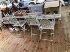 Metal lattice work design garden table and six folding chairs, table 153cm by 76cm.