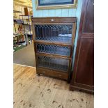 Early 20th Century mahogany three height leaded glazed door bookcase with base drawer,