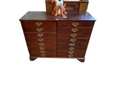 Mahogany finish filing chest of two banks of four drawers raised on bracket feet, 99cm by 40cm.