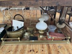 Collection of oil lamps, brass fender, coal bucket and scuttle, mantel clock, cigarette cards, etc.