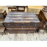 Vintage wood and metal bound travelling trunk, 65cm by 98cm by 58cm.