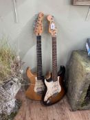 Two electric guitars, named Strat Squire and Pacifica Yamaha.