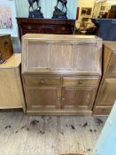 Ercol Golden Dawn bureau, the fall front above two drawers and two cupboard doors, 108cm by 93.