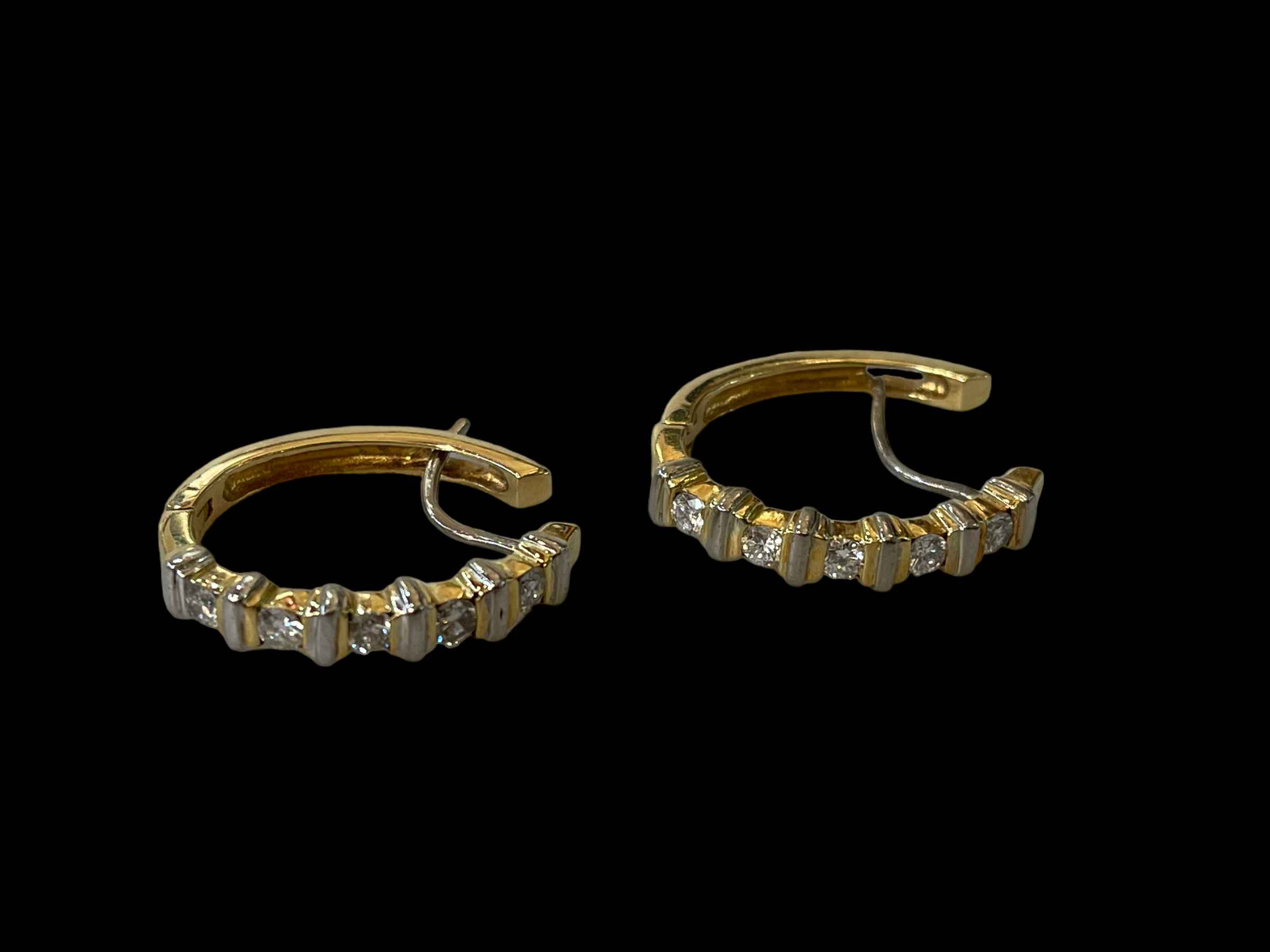 Pair diamond set gold earrings, each one set with five brilliant cut diamonds.