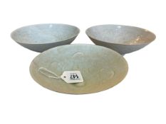 Three Celadon bowls, largest 20cm diameter.