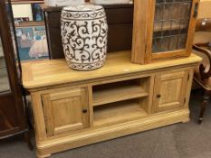 Contemporary light oak two door entertainment unit and barrel stool.