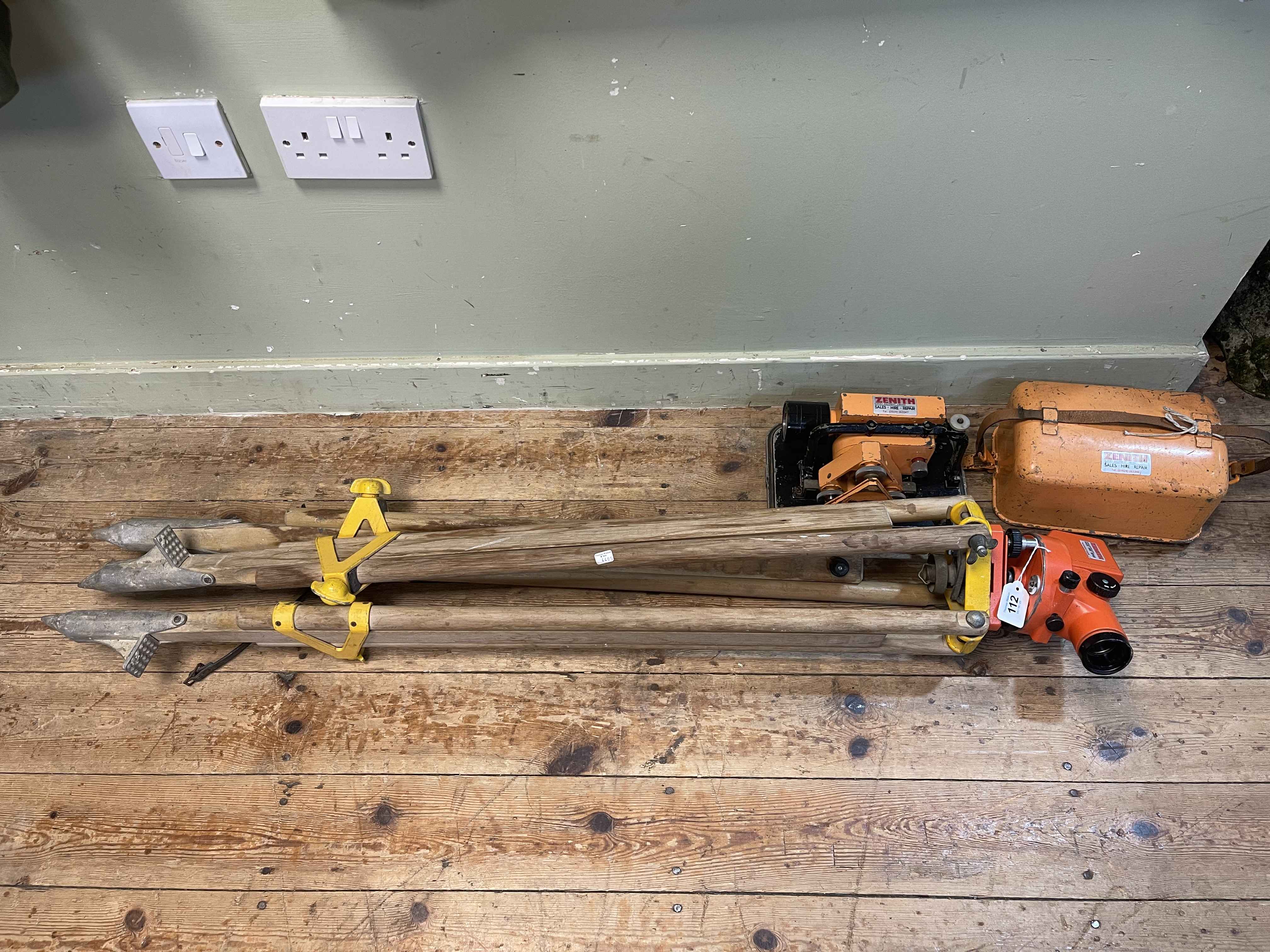 Two Zenith Surveyor Theodolites and a tripod stand.