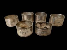 Six silver napkin rings including pair of oval Sheffield 1917.