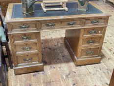 Late 19th/early 20th Century oak nine drawer pedestal desk, 74cm by 122cm by 68cm.