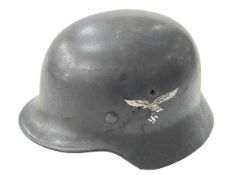 WWII helmet with eagle emblem.