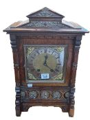 A Continental oak and gilt framed bracket clock with lion head side decoration, 45cm high.