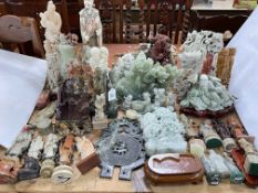 Large collection of soapstone, jade coloured and other carvings.