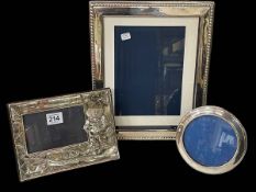 Silver 'Fishing' photograph frame and two others, largest 31cm by 26cm (3).