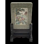 Chinese table plaque decorated with figures on promontory within celadon border, 17cm by 12cm,