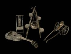 Four small silver models; guitar, chair, rickshaw and stove stand with cauldron.
