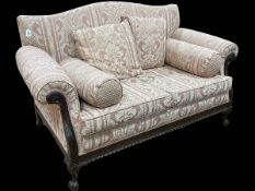 Mahogany framed Chippendale style two seater settee on ball and claw legs.