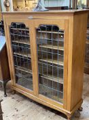 Early 20th Century golden oak leaded glazed two door bookcase, 139cm by 121.5cm by 39cm.