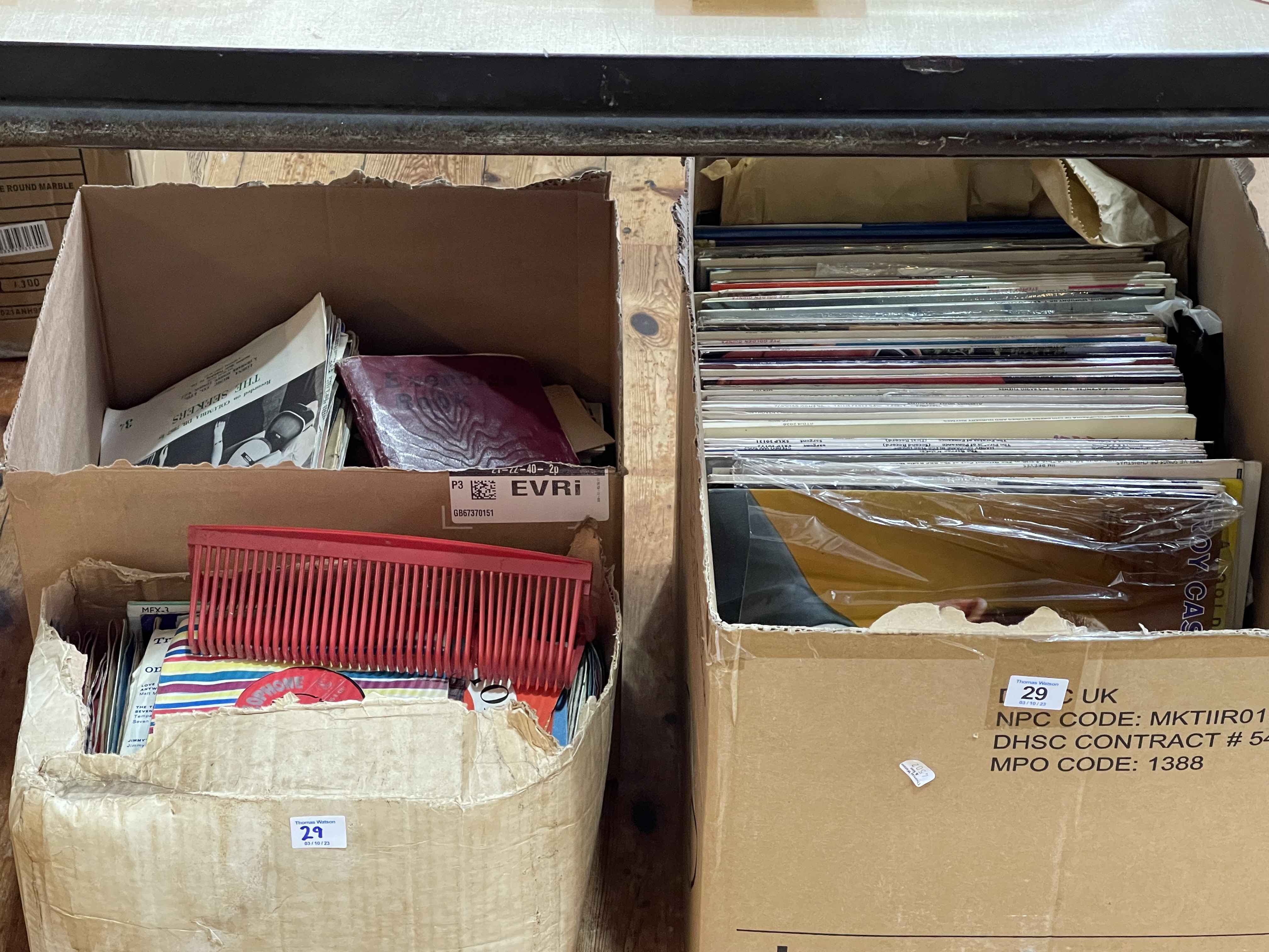 Three boxes of LP and single records.