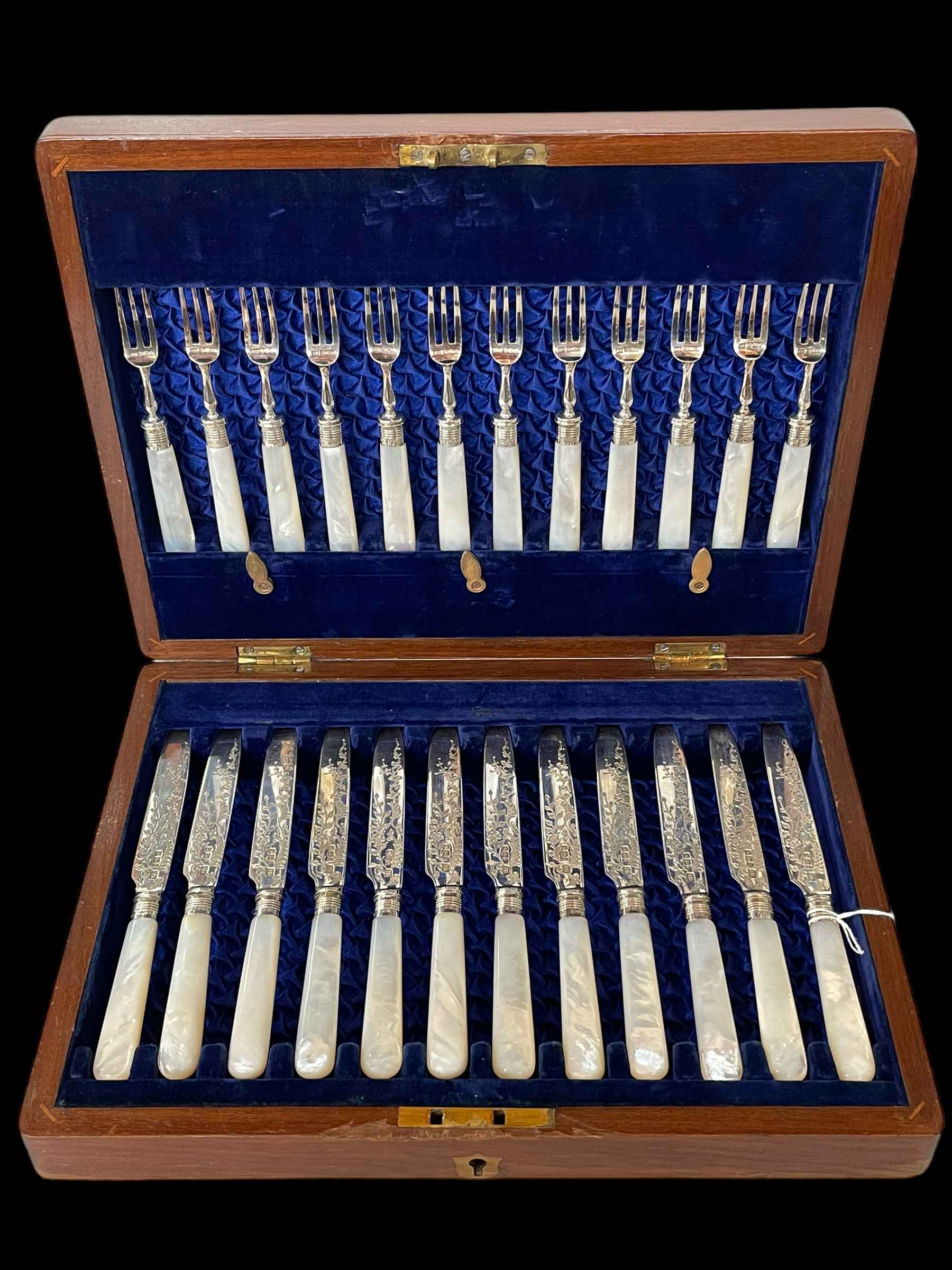 Cased set of twelve silver and mother of pearl dessert knives and forks,