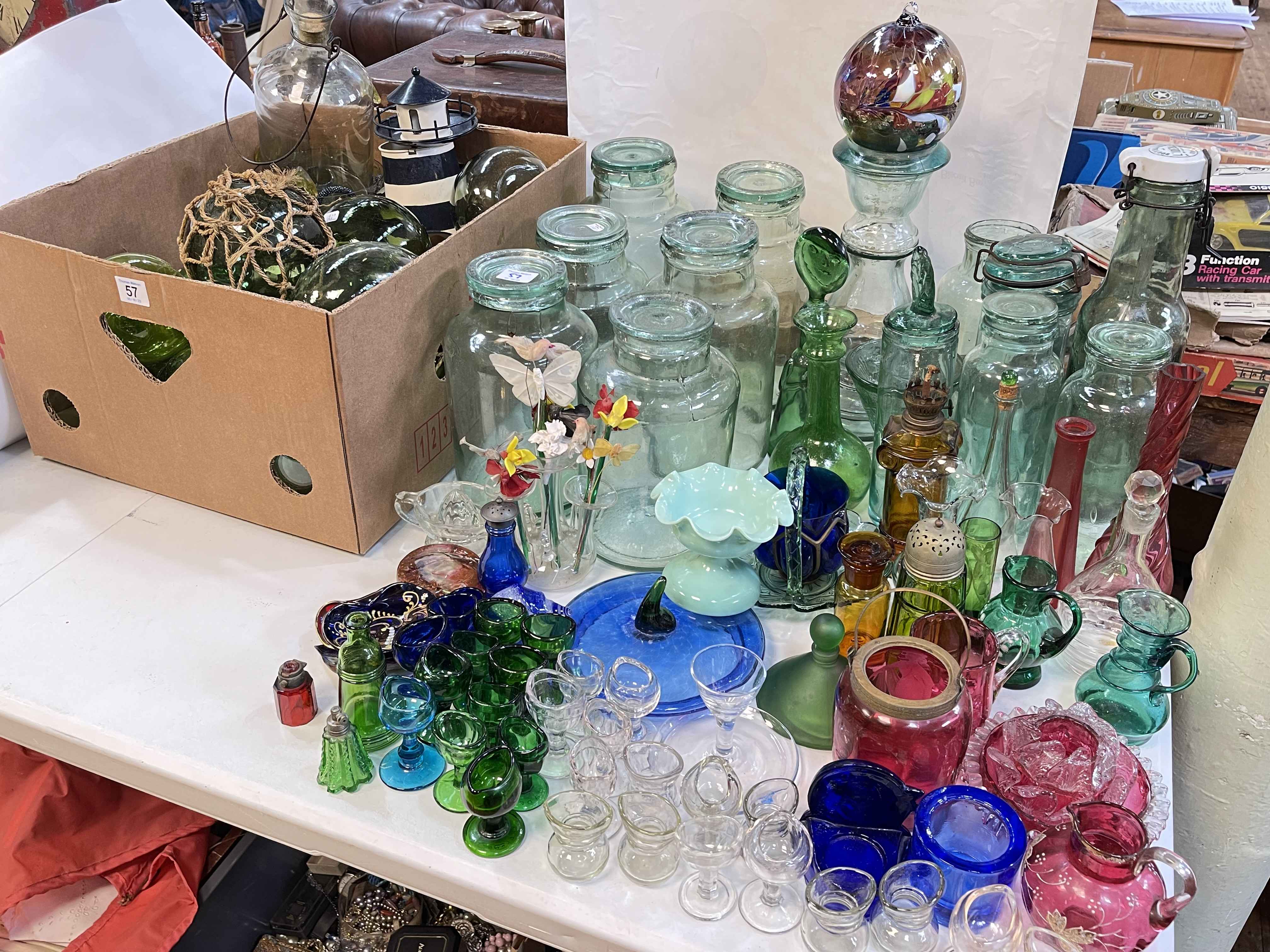 Collection of Victorian glass floats, Victorian eye baths, glass storage jars, etc.