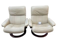 Pair Stressless ivory leather reclining chairs.