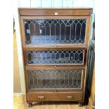 Early 20th Century mahogany three height leaded glazed door bookcase with base drawer,