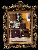 Rectangular rococo style gilt framed bevelled wall mirror, 120cm by 87cm.